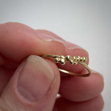 Load image into Gallery viewer, granulated yellow gold stacking ring size 8 in hand on white background  ooak handcrafted ethically made
