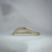 Load image into Gallery viewer, A close-up image of a handcrafted yellow gold wedding band with a high arch and rustic texture. Made with recycled ethical gold and stamped with 10k, 14k, or 18k. Available in a range of sizes