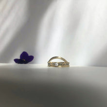 Load image into Gallery viewer, A close-up image of a handcrafted yellow gold wedding band with a high arch and rustic texture. Made with recycled ethical gold and stamped with 10k, 14k, or 18k. Available in a range of sizes.