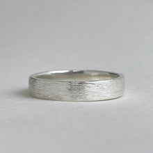 Load image into Gallery viewer, Handcrafted rustic wedding band in Sterling Silver with a unique texture, available in a range of sizes, and gift-wrapped. Perfect as a men's wedding ring or a gift for him.