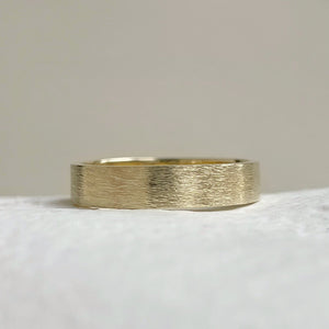 Handcrafted rustic yellow gold wedding band with a brushed texture, made from recycled 10K, 14K, or 18K gold. Perfect for weddings or as a gift for him. Available in a range of sizes.