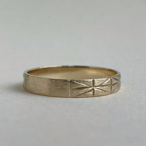 Image of a 4mm yellow gold geometric wedding band, handcrafted with recycled ethical gold, stamped and hallmarked