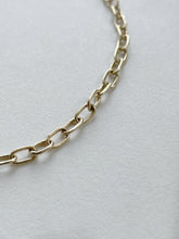 Load image into Gallery viewer, Solid gold charm bracelet with a fine link chain and a rustic texture, crafted by hand with ethically sourced and recycled 10kt yellow gold. Comes with an adjustable clasp and lobster clasp, and a tag with a metal stamp and makers mark.