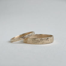 Load image into Gallery viewer, Image of a 4mm hammered finish yellow gold wedding band with a freestyle hammered texture. The band is made with recycled ethical solid 10kt, 14kt, or 18kt yellow gold and is stamped with its karat weight and hallmarked. Available in a range of sizes and made to order, shipping includes tracking within Canada and the United States, and internationally. The ring comes gift-wrapped, making it a special and meaningful present