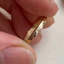 Load image into Gallery viewer, Image of a handcrafted thin 2mm hammered finish yellow gold wedding band with a freestyle hammered texture. The band is ethically sourced and made using recycled 10kt, 14kt, or 18kt yellow gold. The band is stamped with its karat weight and hallmarked. Available in various sizes and made to order, shipping includes tracking within Canada and the United States, and internationally