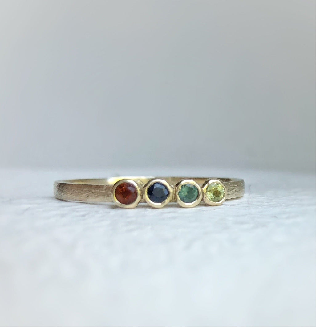 Handcrafted 10kt yellow gold ring with genuine ethically sourced gemstones representing each family member's birth month.