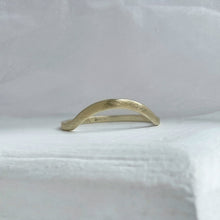 Load image into Gallery viewer, A close-up image of a handcrafted yellow gold wedding band with a high arch and rustic texture. Made with recycled ethical gold and stamped with 10k, 14k, or 18k. Available in a range of sizes.