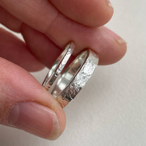 Thin hammered Sterling Silver wedding band with a freestyle texture, available in a range of sizes, and gift-wrapped. Measures 1.5mm in width and 1.25mm in thickness. Perfect as a minimal and unique wedding ring for her