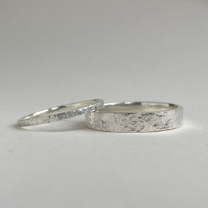 Textured hammered Sterling Silver wedding band with a rustic and unique design, available in a range of sizes, and gift-wrapped. Measures 4mm in width and 1.25mm in thickness. Perfect as a sustainable and eco-friendly wedding band with a personal touch.