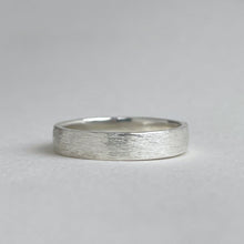 Load image into Gallery viewer, Handcrafted rustic wedding band in Sterling Silver with a unique texture, available in a range of sizes, and gift-wrapped. Perfect as a men's wedding ring or a gift for him.