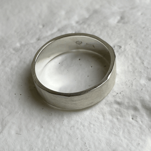 Brushed hammered wedding band made of recycled and ethical Sterling Silver. Rustic men's wedding ring with a freestyle hammered texture. 6mm wide and 1.25mm thick.
