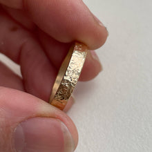 Load image into Gallery viewer, Image of a 4mm hammered finish yellow gold wedding band with a freestyle hammered texture. The band is made with recycled ethical solid 10kt, 14kt, or 18kt yellow gold and is stamped with its karat weight and hallmarked. Available in a range of sizes and made to order, shipping includes tracking within Canada and the United States, and internationally. The ring comes gift-wrapped, making it a special and meaningful present