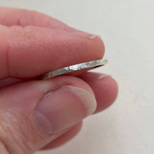 Load image into Gallery viewer, Thin hammered Sterling Silver wedding band with a freestyle texture, available in a range of sizes, and gift-wrapped. Measures 1.5mm in width and 1.25mm in thickness. Perfect as a minimal and unique wedding ring for her.