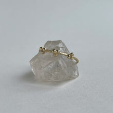 Load image into Gallery viewer, scs recycled ethically sourced yellow gold stacking ring with granulation details handcrafted sitting on a quartz crystal on white background
