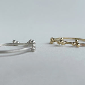 scs recycled ethical yellow gold and sterling silver versions of the granulation design both handcrafted close up on white background