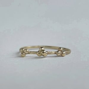 scs recycled yellow gold stacking band with granulation details handcrafted front view on white background