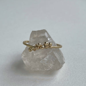 scs recycled yellow gold ring size 8 granulation stacking ring on quartz with white background 