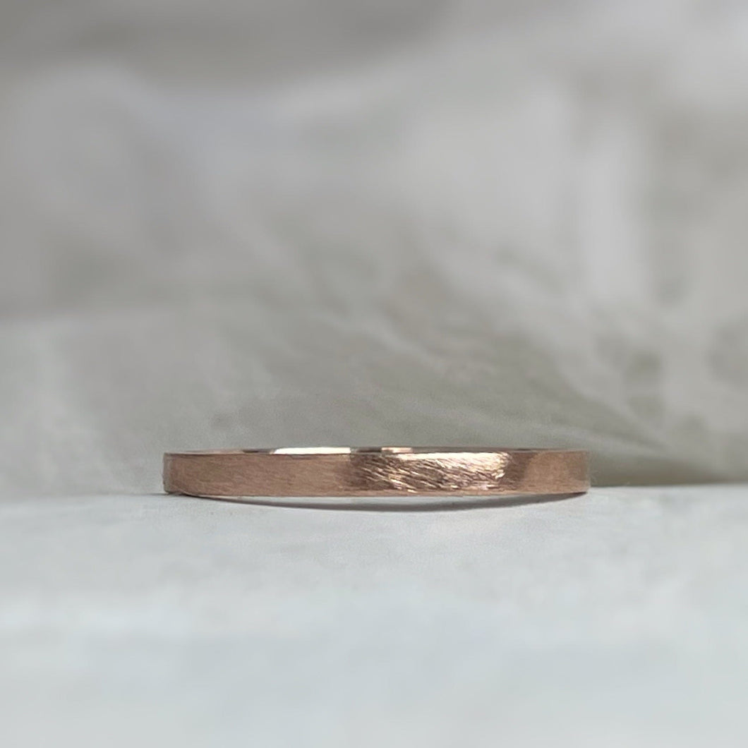 Handcrafted 2mm rose gold wedding band with minimal rustic texture made from recycled ethical gold