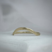 Load image into Gallery viewer, A close-up image of a handcrafted yellow gold wedding band with a high arch and rustic texture. Made with recycled ethical gold and stamped with 10k, 14k, or 18k. Available in a range of sizes
