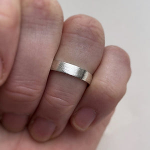 Handcrafted rustic wedding band in Sterling Silver with a unique texture, available in a range of sizes, and gift-wrapped. Perfect as a men's wedding ring or a gift for him.