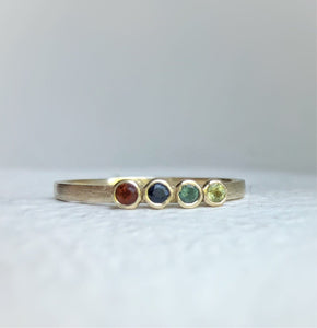 Handcrafted 10kt yellow gold ring with genuine ethically sourced gemstones representing each family member's birth month.