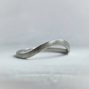Handcrafted high arch curved wedding band in thin rustic white gold with minimal texture, ethically sourced