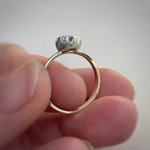 Load image into Gallery viewer, Pear shaped solitaire featuring a 6x4mm AA white sapphire. The band is yellow gold with a white gold setting. A rustic texture is applied.
