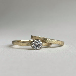 Rustic rose setting white sapphire engagement ring on a yellow gold band