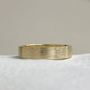 Handcrafted rustic yellow gold wedding band with a brushed texture, made from recycled 10K, 14K, or 18K gold. Perfect for weddings or as a gift for him. Available in a range of sizes.