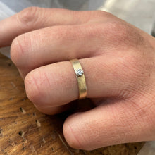 Load image into Gallery viewer, A close-up of a Solitaire Square Male Wedding Band in 10kt yellow gold and white gold setting, featuring a square white sapphire in the center
