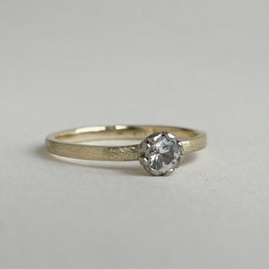 Rustic rose setting white sapphire engagement ring on a yellow gold band