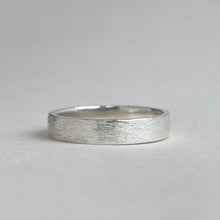 Load image into Gallery viewer, Handcrafted rustic wedding band in Sterling Silver with a unique texture, available in a range of sizes, and gift-wrapped. Perfect as a men&#39;s wedding ring or a gift for him.

