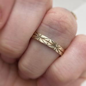 Image of a 4mm yellow gold geometric wedding band, handcrafted with recycled ethical gold, stamped and hallmarked